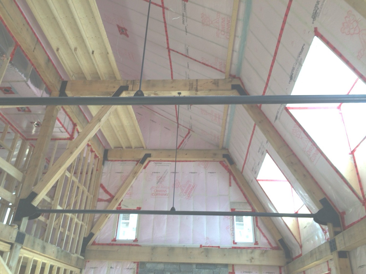 Cathedral ceiling and walls filled with blown-in insulation before drywall