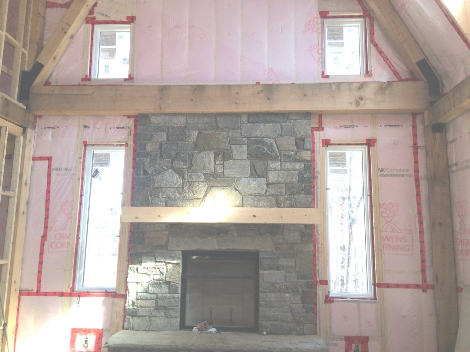 Two-storey great room with walls netted and filled with blown-in insulation