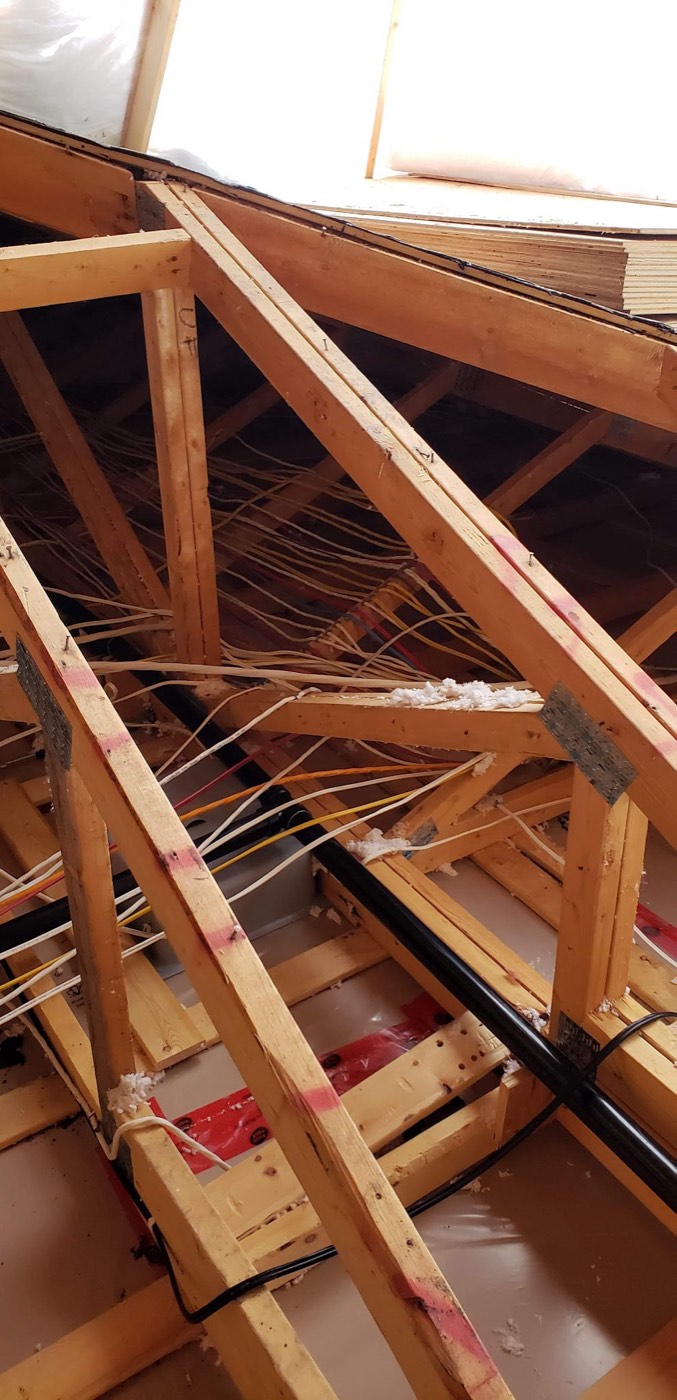 Attic rafters with netting stapled across the bays before insulation is blown in