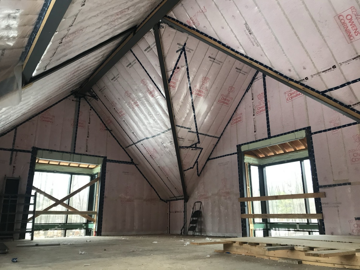 Cathedral ceiling insulated between the rafters with two windows in the gable end