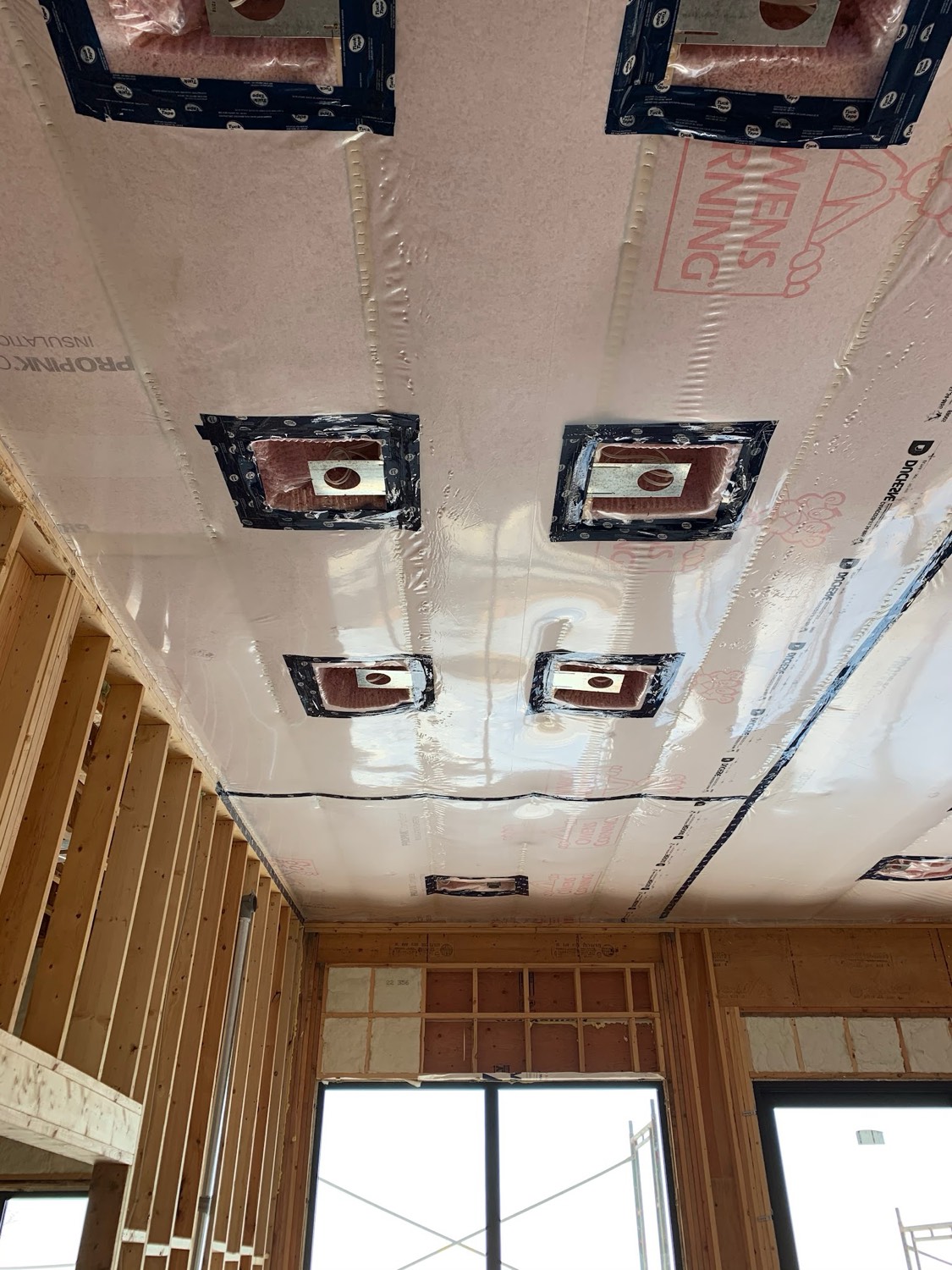 Ceiling with light fixture boxes taped and sealed against air leakage
