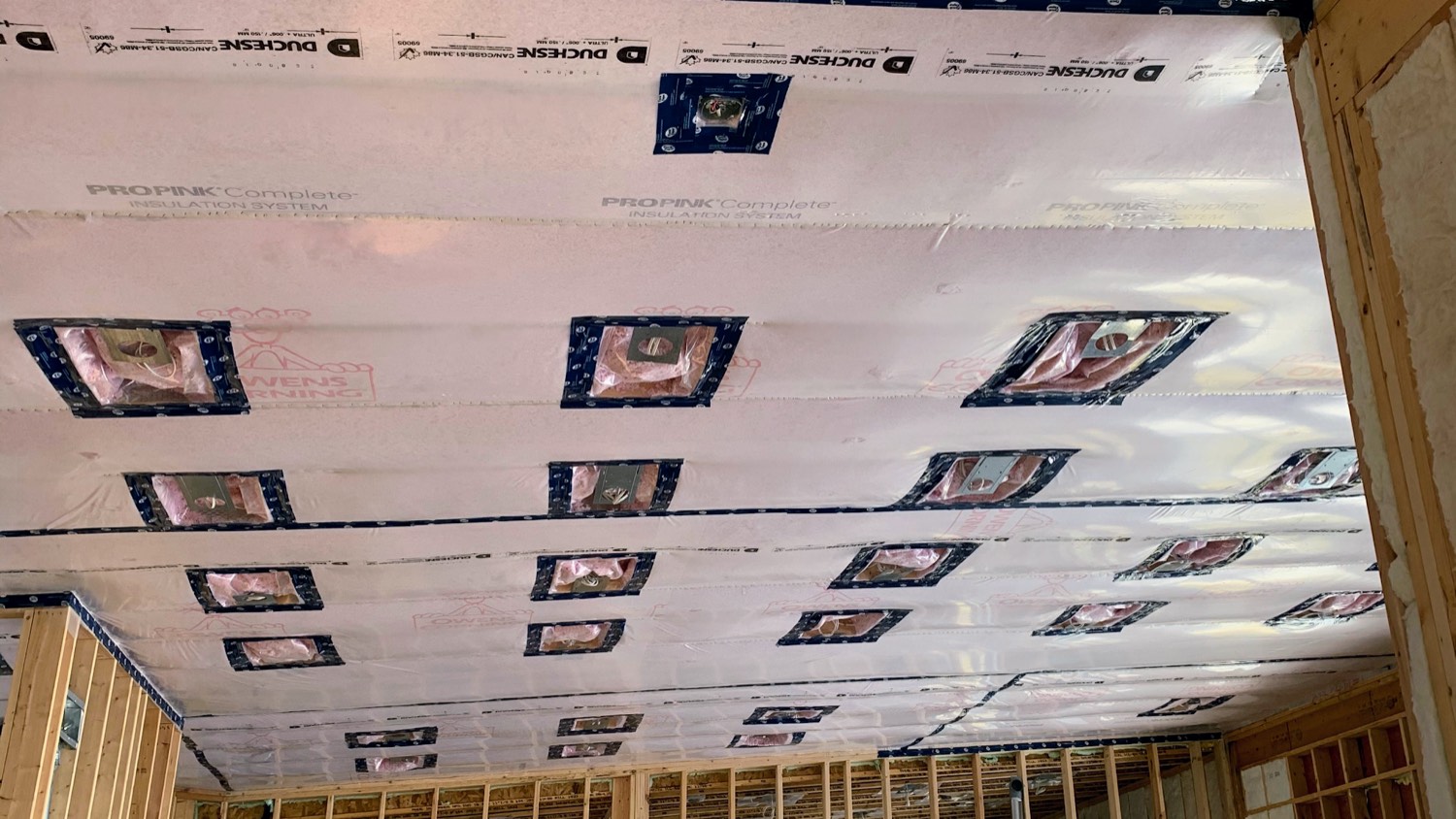 Insulated ceiling with the membrane detailed and light fixture boxes taped and sealed