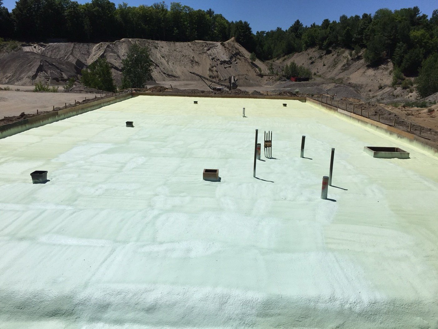 Large shop floor covered with an even layer of spray foam insulation