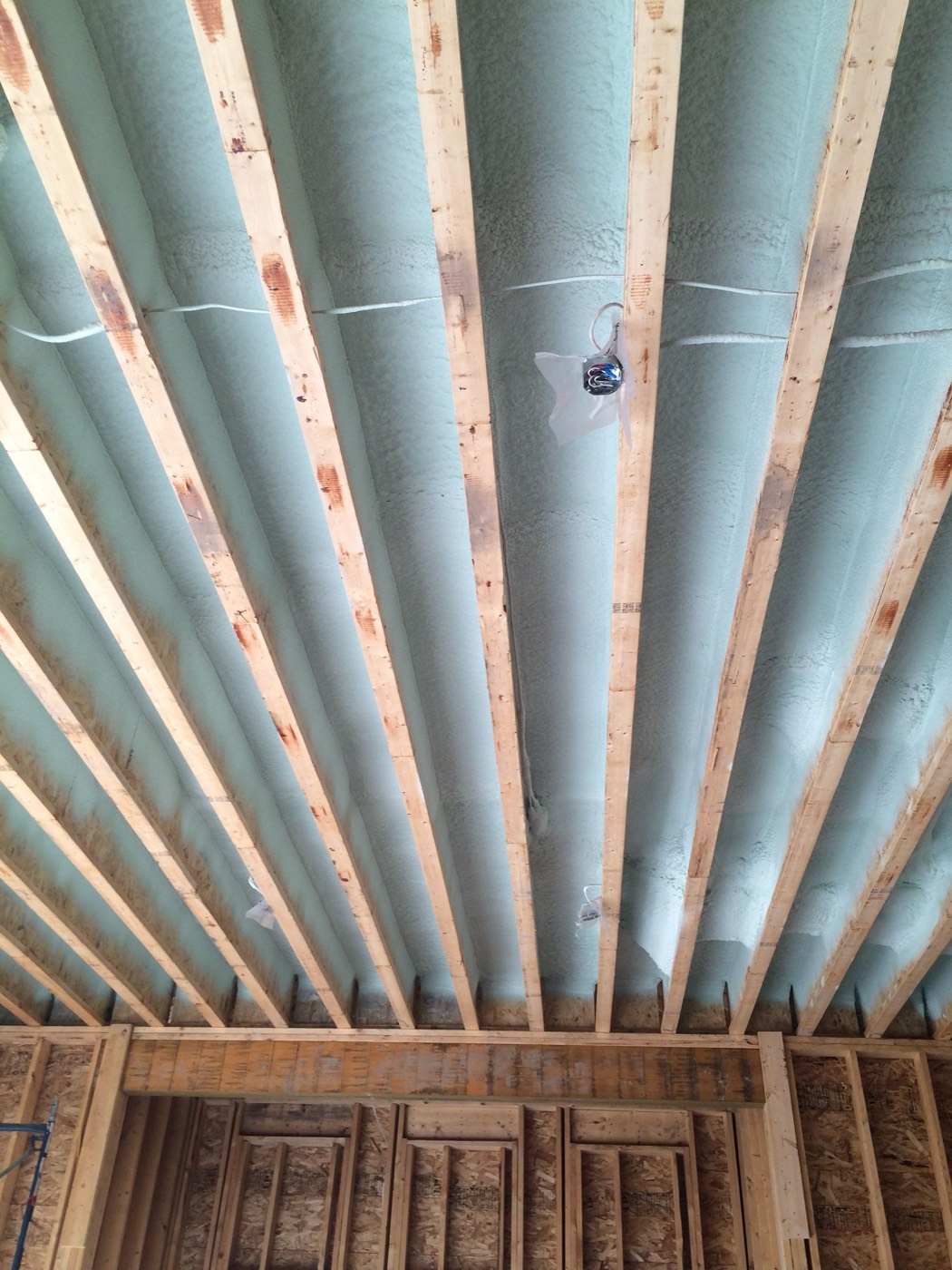 Garage ceiling with insulation installed between structural ribs