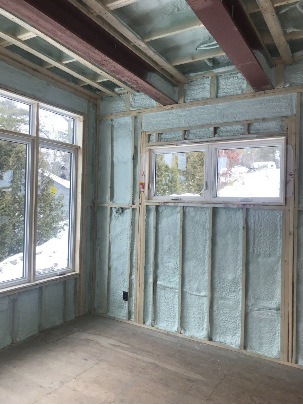 Insulation detailed around a window opening in a framed wall